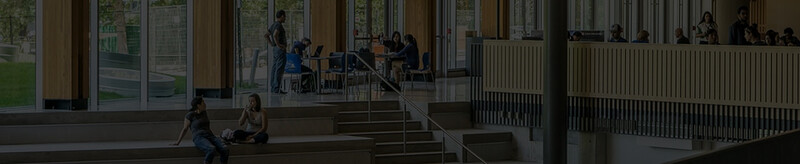 students sitting in a university commons area