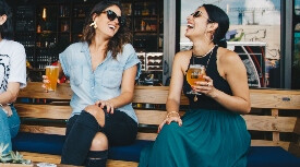 women drinking beer together