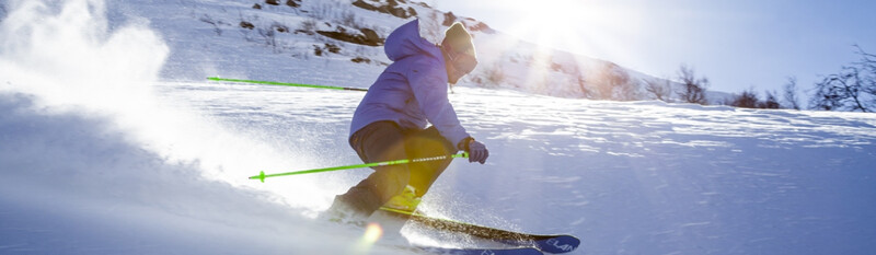 person skiing down slope