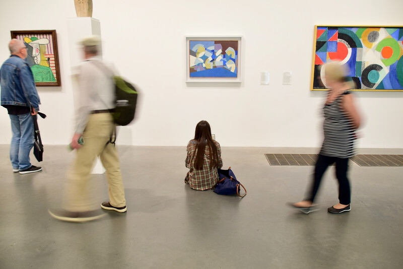 people looking at an art exhibit