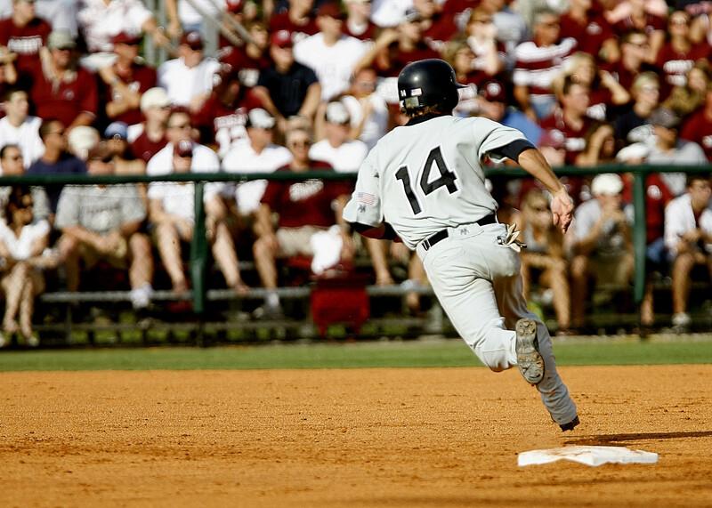baseball player running over base