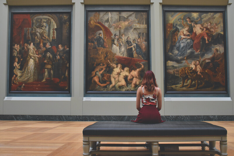 woman looking at art exhibit