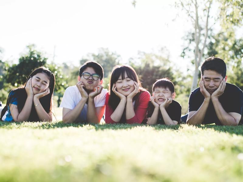 family smiling at park