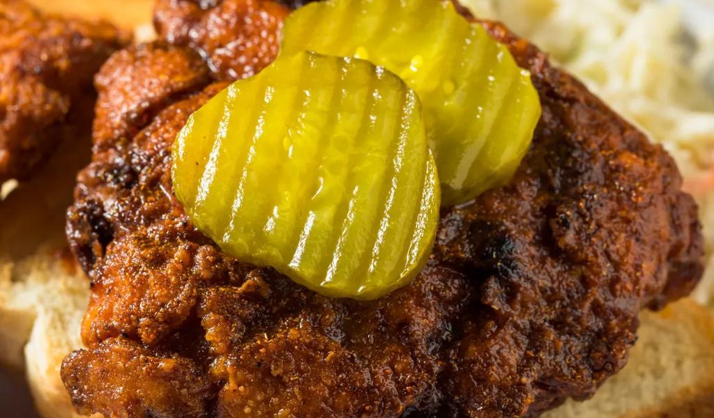 Hot chicken sandwich with pickles from Hattie B's Hot Chicken 