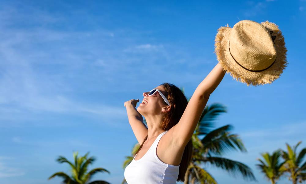 woman in sunshine and palm trees