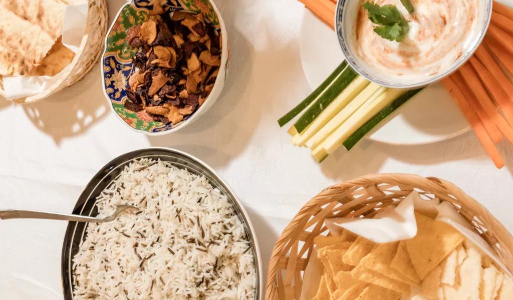 Assorted dishes with rice, chips, and dips