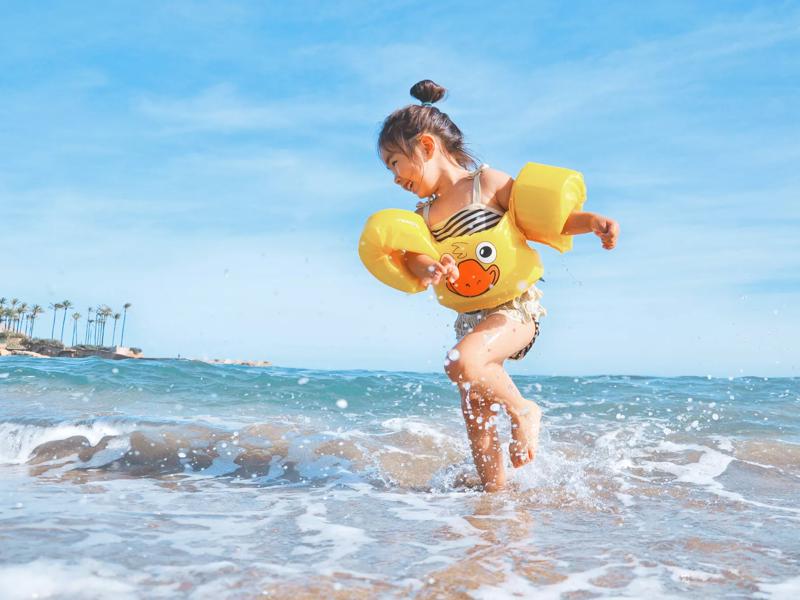 little girl splashing in ocean