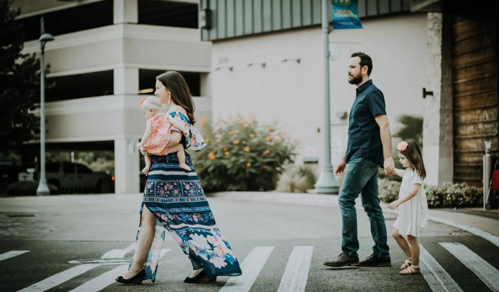 family walking across street