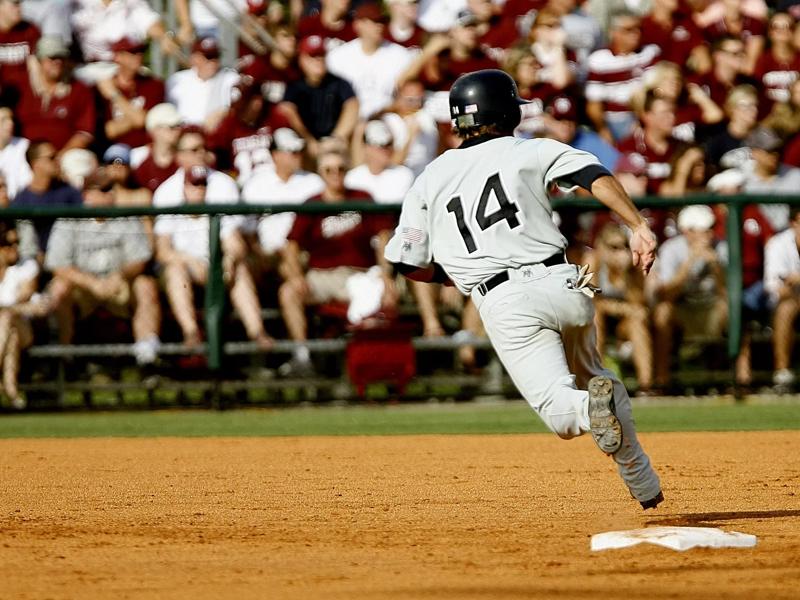 baseball player running over base