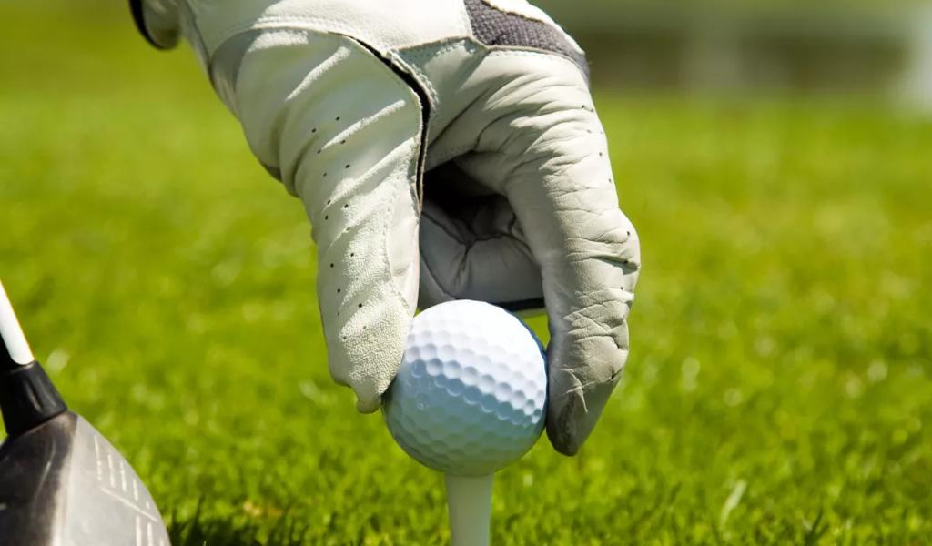 Golfer placing ball