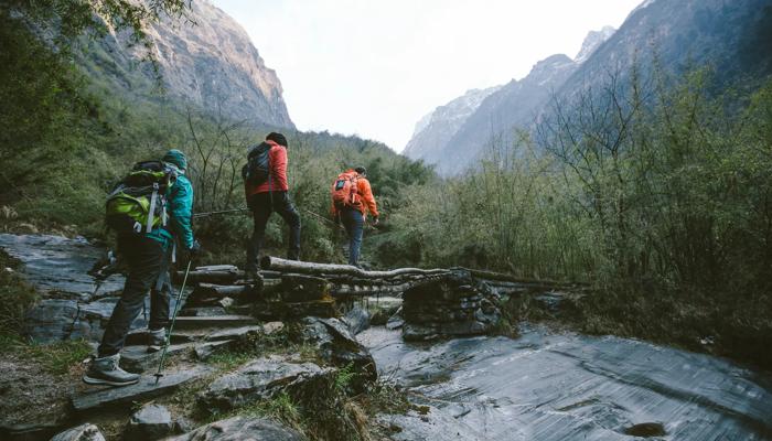 Group of trekkers cross the bridge