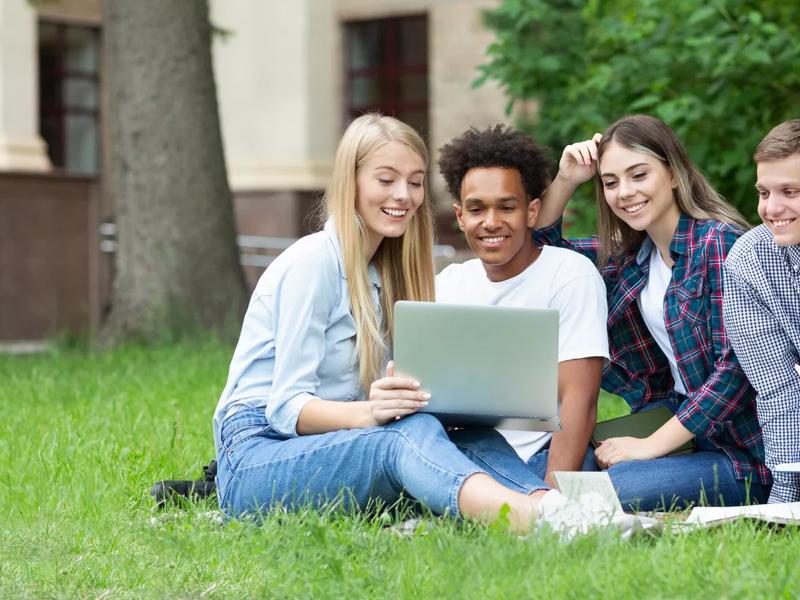 college students outside on the grass