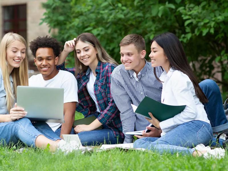 students sitting on lawn