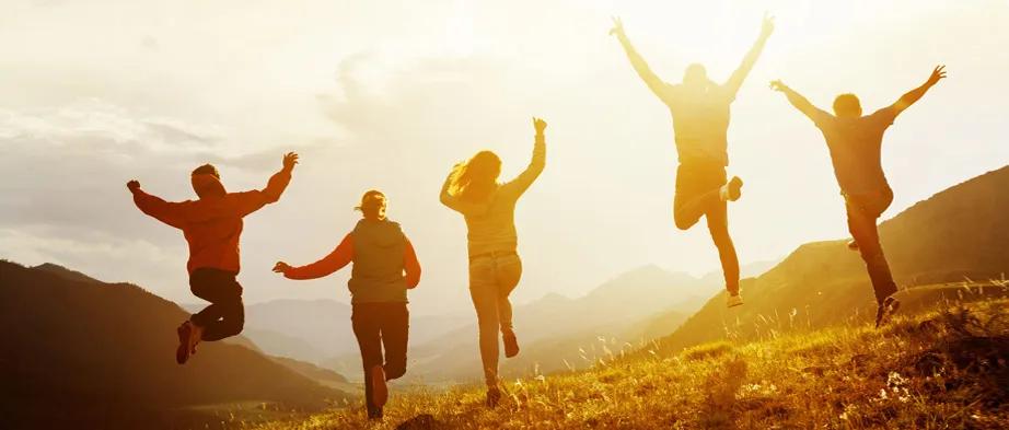 People jumping on a hill in the Fall