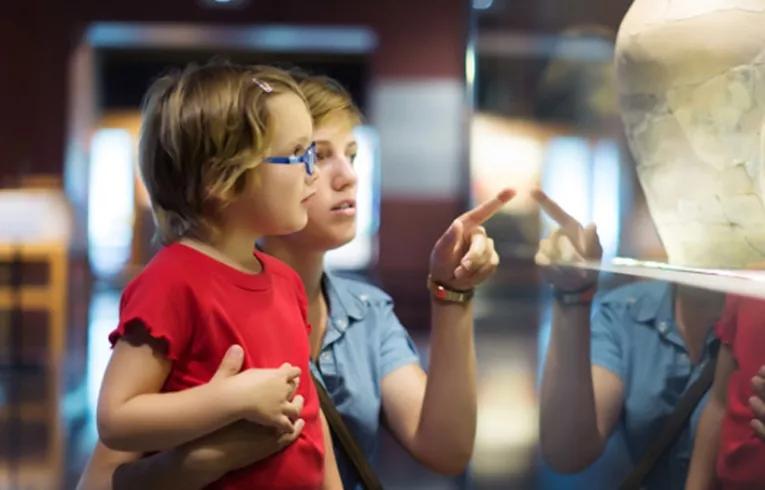 family looking at museum exhibit