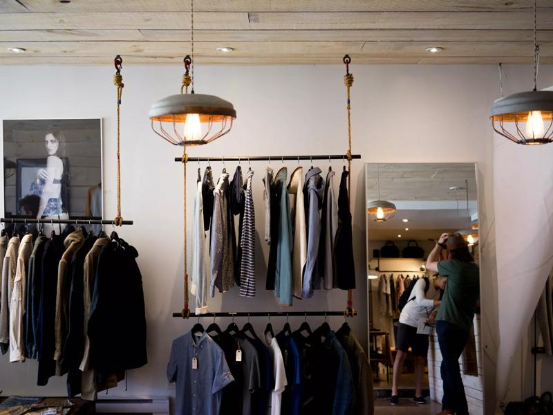 racks of clothes at a shopping mall