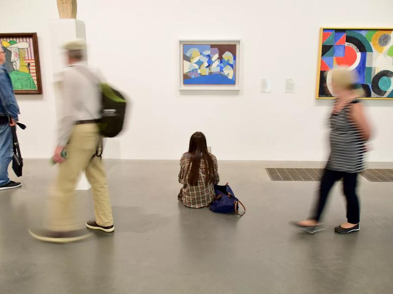 people looking at art exhibit