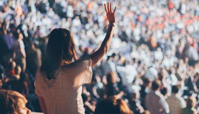 people cheering at a concert