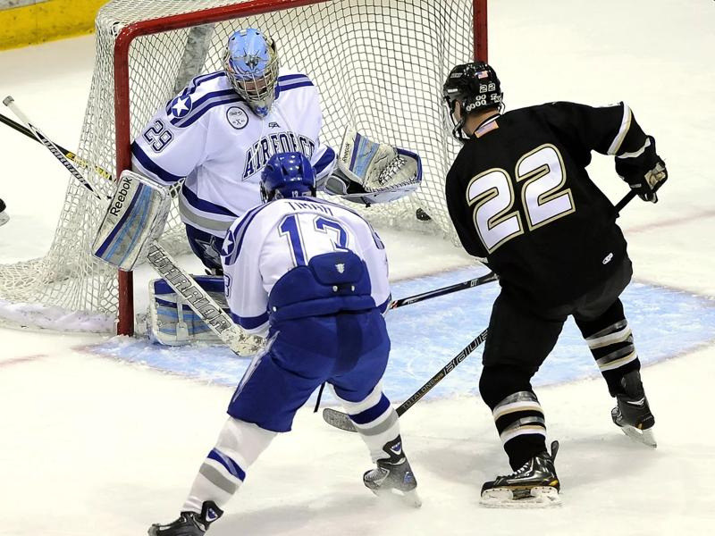 hockey players around goal