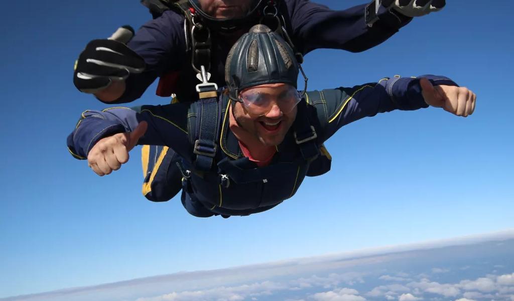 Tandem skydiving over landscape