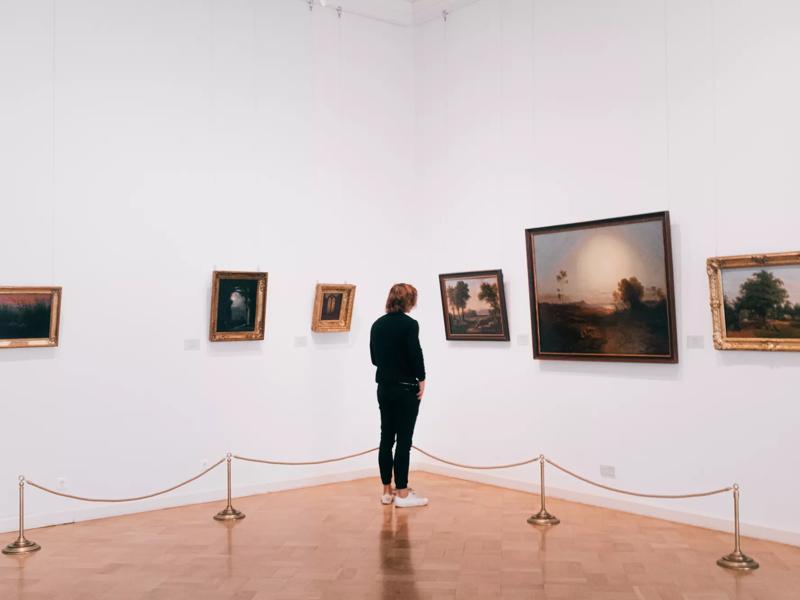 man looking at art at a museum