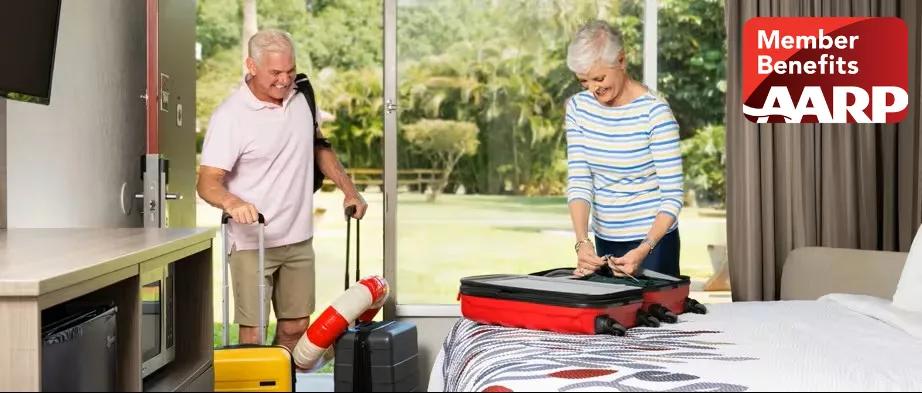 Couple unpacking suitcases inside their room