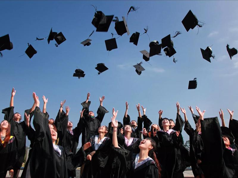 college students throwing caps