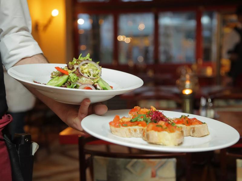 server with food at restaurant