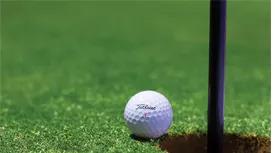 golf ball nearing hole