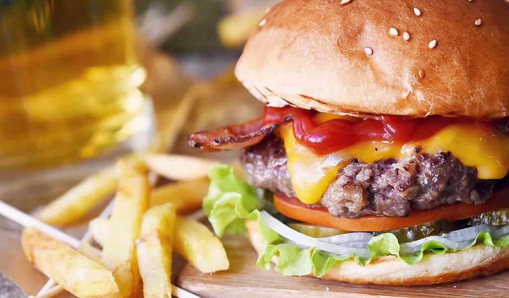 A handmade cheeseburger with fries at the Pharmacy Burger Parlor & Beer Garden