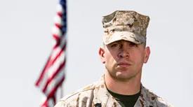 soldier next to american flag