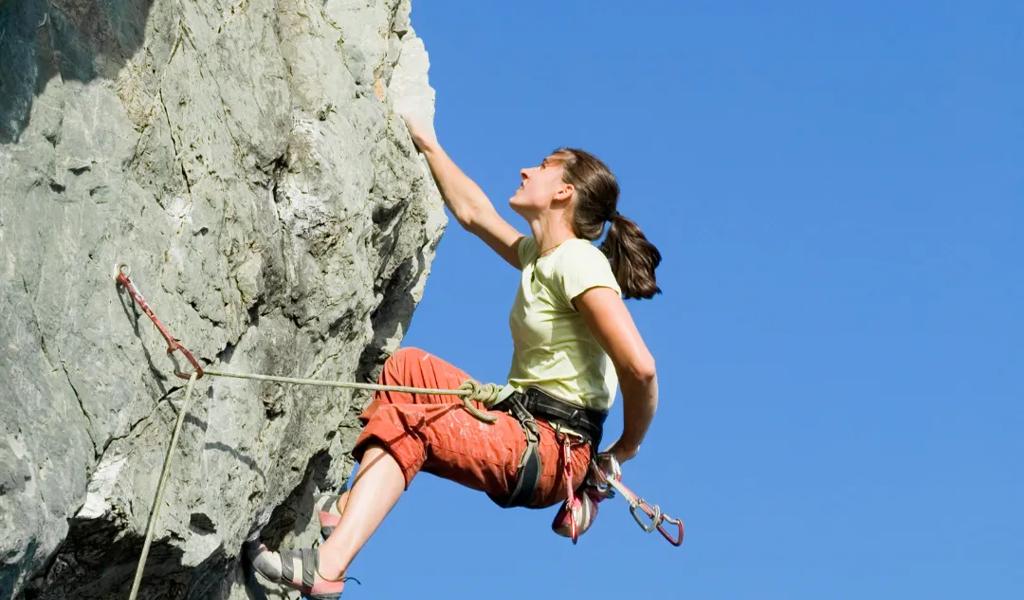 Female rock climber ascending