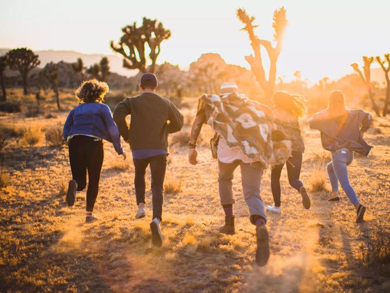 friends running through desert