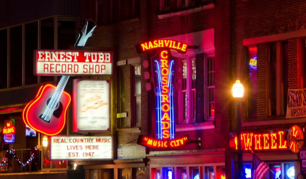 Neon signs of bars and live music venues in downtown Nashville at night